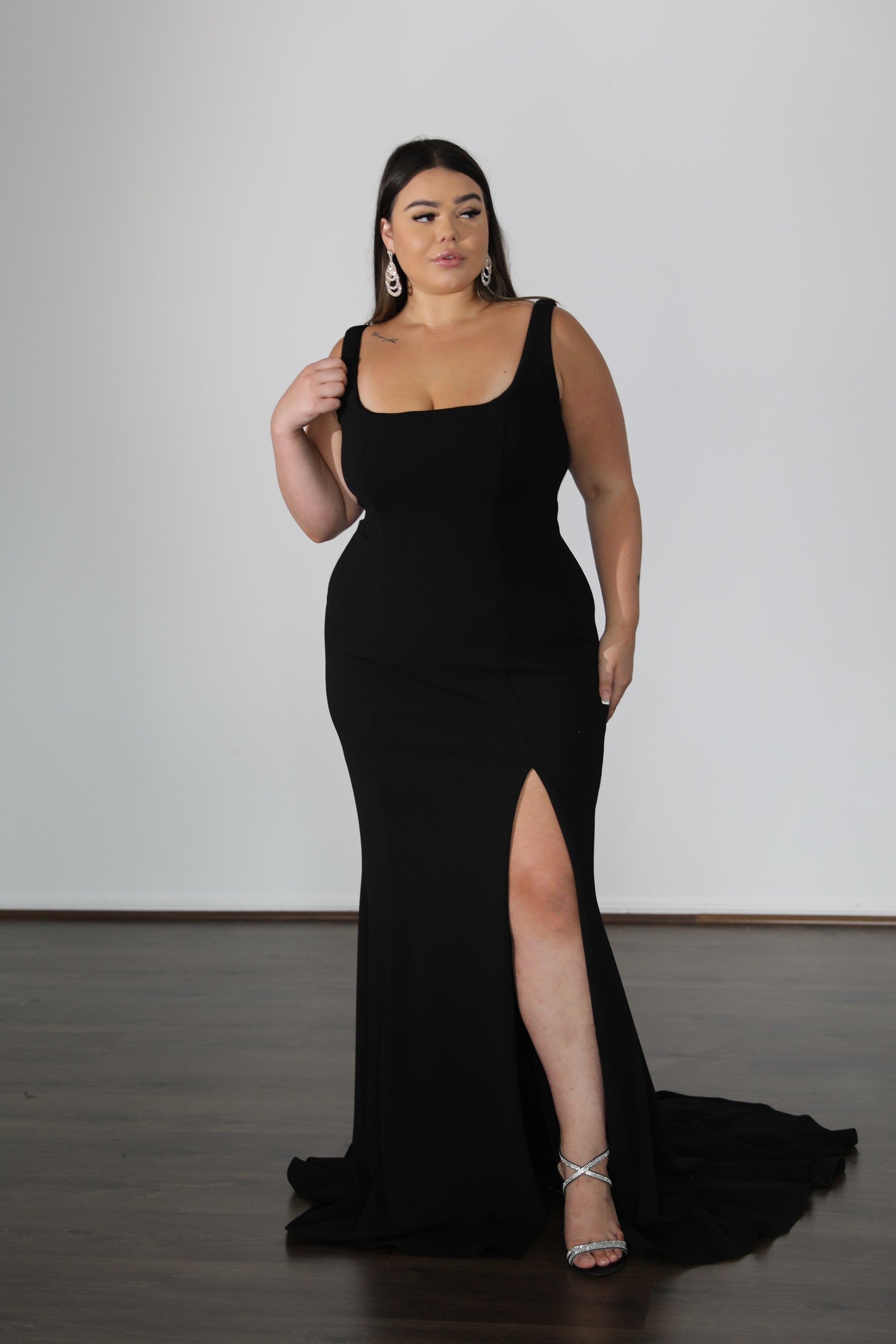 black u-neckline and thigh split on fitted formal gown with long train