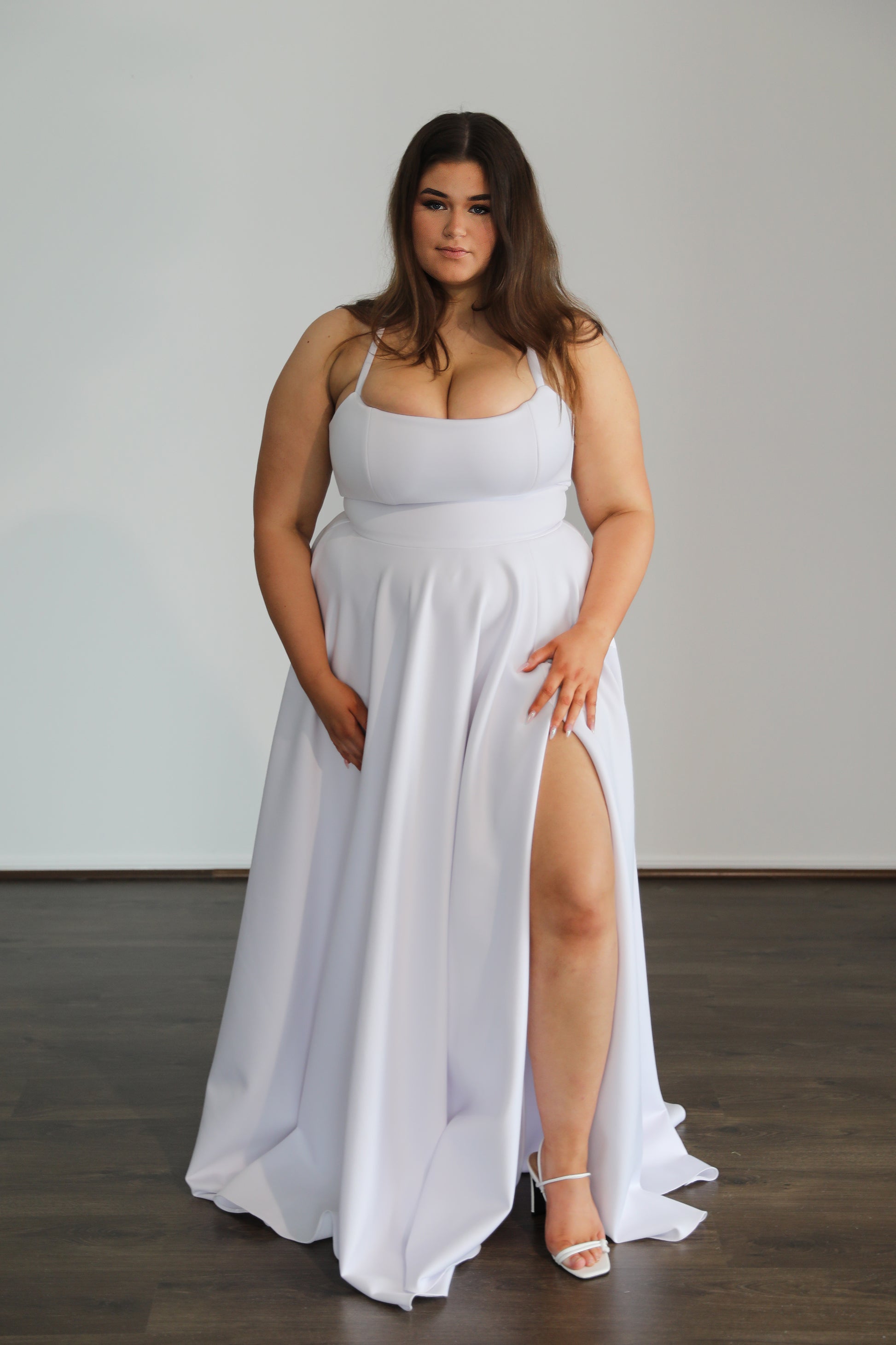 brunette model in white formal gown