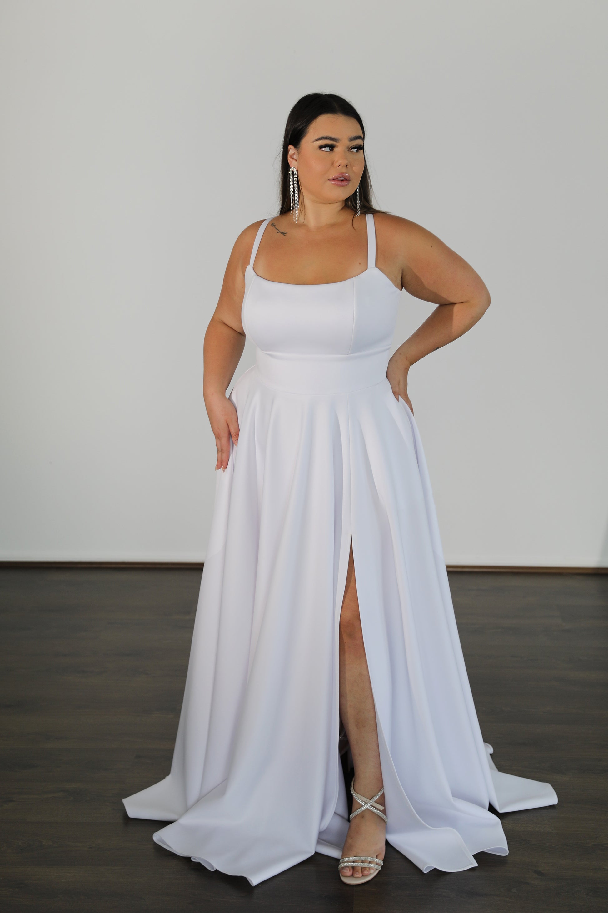 flowing skirt and fitted top with thin straps on formal dress