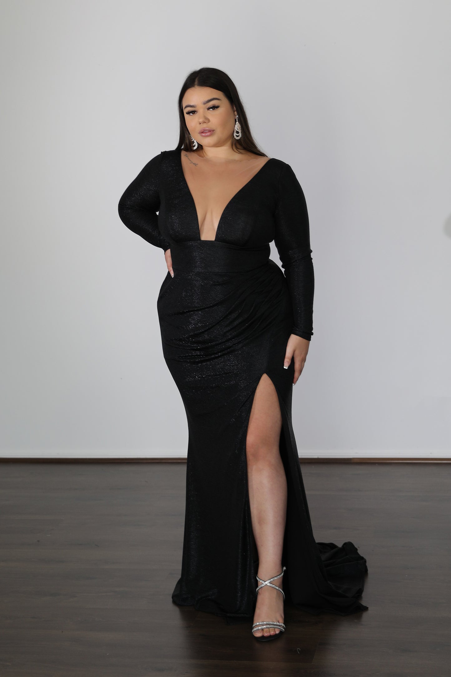 low v-cut neckline with long sleeves and thigh slit on black formal gown