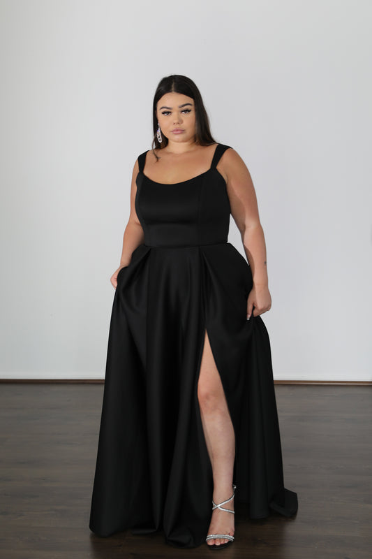 model posing holding skirt of black formal dress