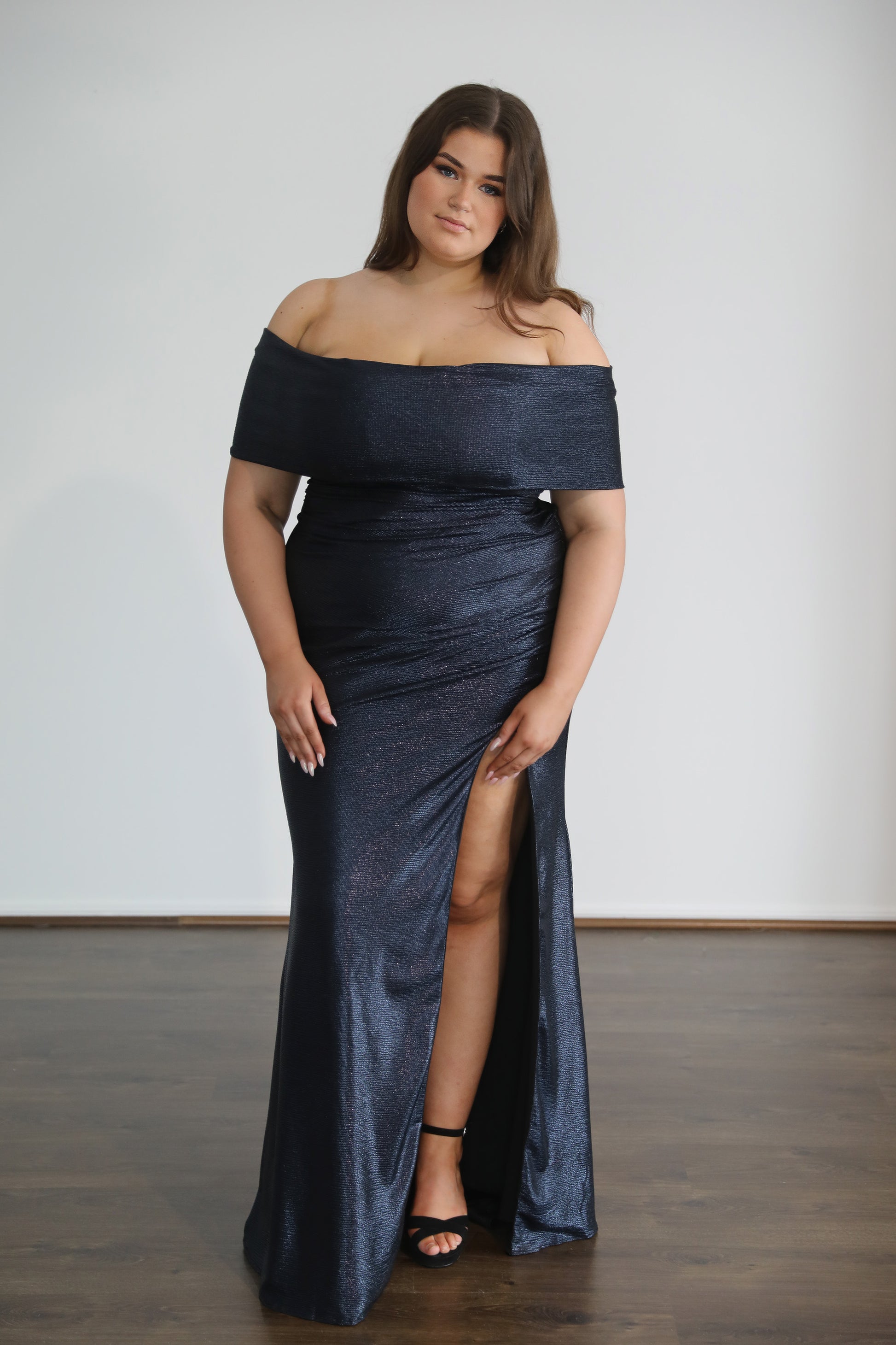 navy formal gown worn by model with brown hair